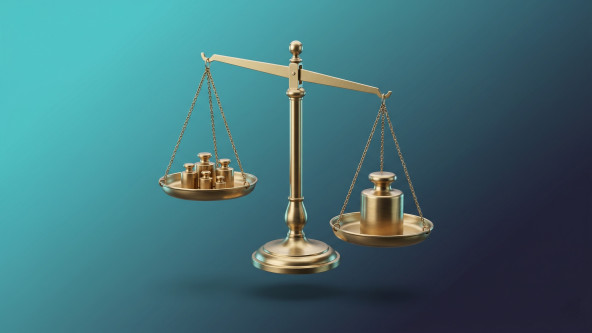 Laravel freelancer vs agency: precision brass balance scale, out of balance and tipped slightly to the right. The left pan holds five small brass weights, the right pan holds a single large, heavy brass weight and outweighs the five small ones