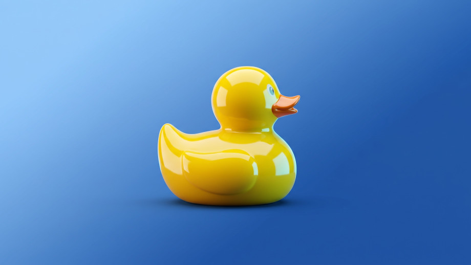 Rubber duck representing both the playfulness and a debugging technique in software engineering